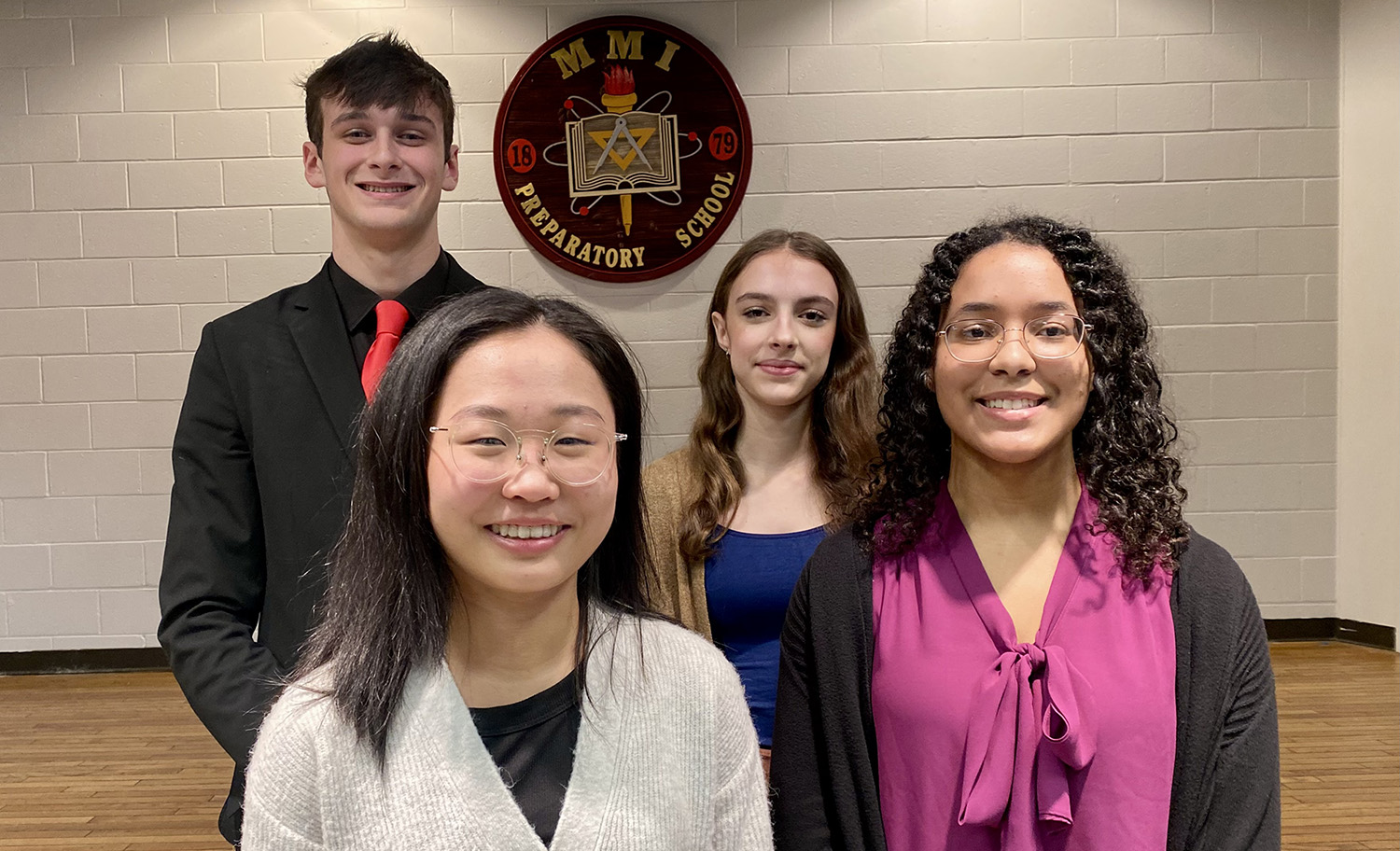 A group of four MMI students smiling for the camera