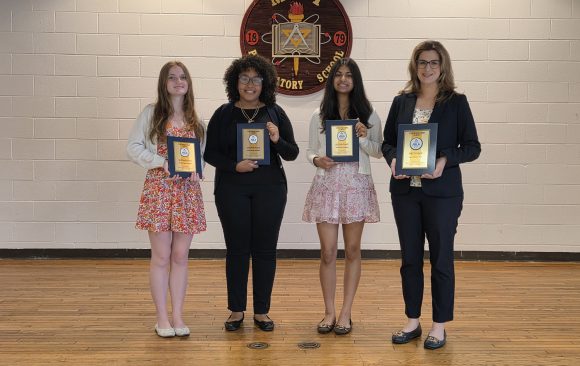 From left to right: Amanda Stoffa, Yoreimy Aponte, and Ruhani Shah stand with their advisor, Mrs. Katherine Zucco, who is holding MMI’s 1st Place Local Market Share award.