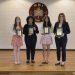 From left to right: Amanda Stoffa, Yoreimy Aponte, and Ruhani Shah stand with their advisor, Mrs. Katherine Zucco, who is holding MMI’s 1st Place Local Market Share award.